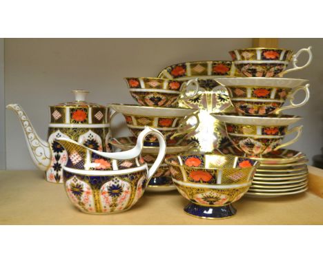 A Royal Crown Derby 1128 pattern comprehensive tea service, comprising pedestal cup, saucers, bread and butter plate, milk ju