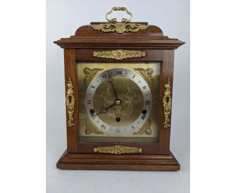 A reproduction Elliott bracket clock retailed by Harrods, the case having a stepped pediment with applied gilt metal mounts, 