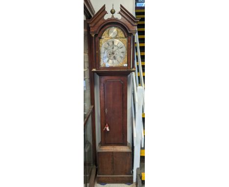 A George III oak longcase clock, the case having a broken stepped pediment with ball finial to the centre, the arched dial si