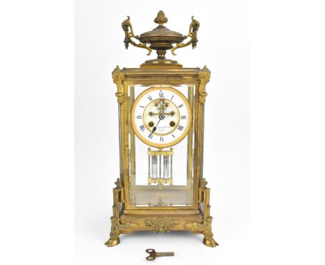 A French 19th century ormolu mounted four glass mantle clock, with central enamel dial with Roman numerals, visible escapemen