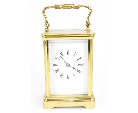 A 20th century French carriage clock, the brass case with bevelled glass panels, enclosing a white enamel dial with Roman num