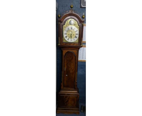 An 18th century mahogany longcase clock having pierced fretwork pediment with ball finials, fluted pillars flanking the arche