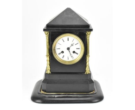 A Victorian black slate mantle clock, of typical architectural form with gilt metal Corinthian capital columns, the circular 