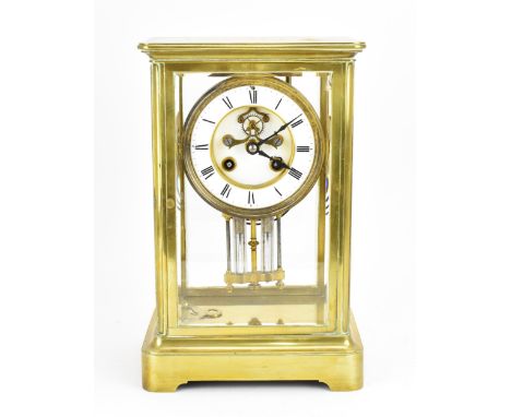 A French 19th century brass mounted four glass mantle clock, with central enamel dial with Roman numerals, visible escapement