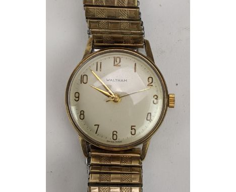 A Waltham, manual wind, gents, 9ct gold wristwatch, circa 1960s, having Arabic numerals and centre seconds, later expanding g