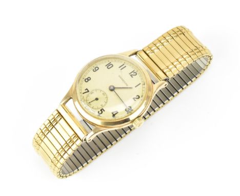 A Garrard, manual wind, gents, 9ct gold wristwatch, the dial having Arabic numerals and subsidiary seconds dial, with a later