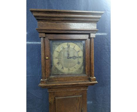 An 18th century 30 hour oak longcase clock, the case having a stepped pediment and pillars flanking the square gilt dial havi