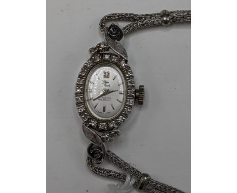 A Filippe Girard manual wind, ladies 14k stamped white gold cased wristwatch inset with 24 diamonds, having a silvered dial w