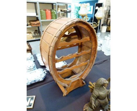 BARREL SHAPED WINE RACK. Wooden barrel shaped wine rack, holds twelve bottles and comes with vintage wooden corkscrew