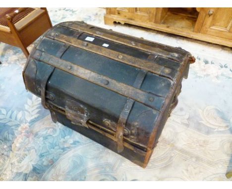 DOMED TRAVEL TRUNK. Domed wood bound travel trunk with lined interior