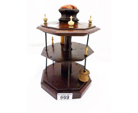 MULTI BOBBIN HOLDER. Antique mahogany multi bobbin holder with bone fittings and pin cushion H: 25 cm