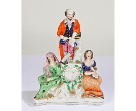 19th Century Staffordshire clock group, modelled as William Shakespeare standing over a clock face with a seated lady either 