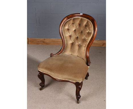 Victorian mahogany nursing chair, the arched button back above a stuff over seat and hipped cabriole legs, the seat 60cm wide