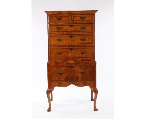 Good quality walnut chest on stand of small proportions, in the 18th Century style, the rectangular top with feather crossban
