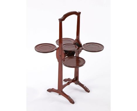 20th Century mahogany metamorphic cake stand, bearing makers label 'The Monoplane', with press button action and five platfor