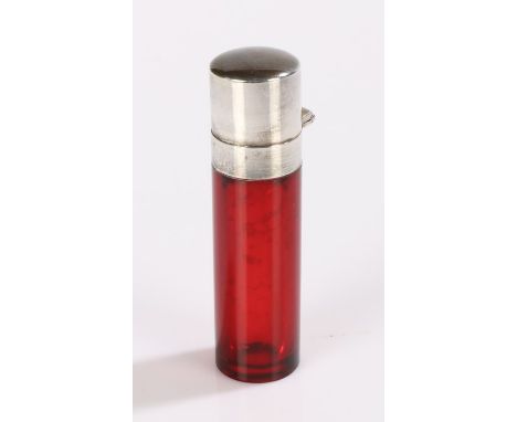 Late Victorian white metal and ruby glass scent bottle, having plain white metal hinged lid enclosing a clear glass stopper a