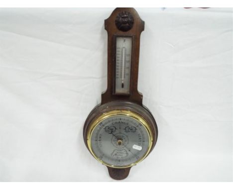 A Shortland banjo barometer / thermometer on oak mount This lot must be paid for and collected (or despatched) no later than 