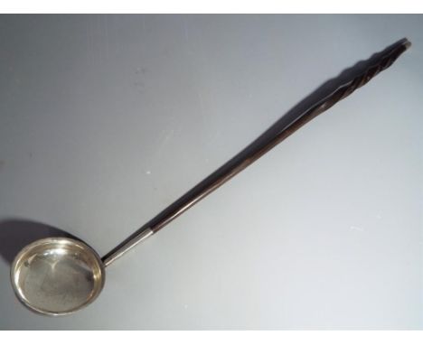A Georgian white metal (presumed silver) toddy ladle with bone handle This lot must be paid for and collected (or despatched)