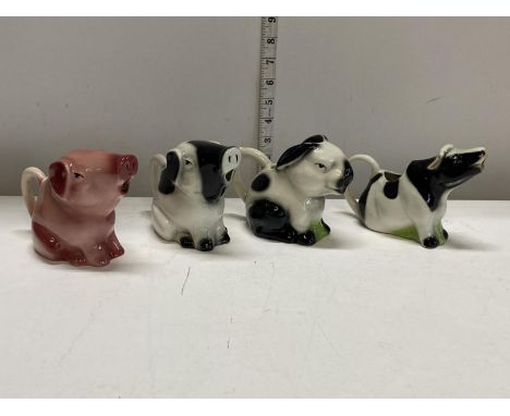 Four assorted antique ceramic creamers 
