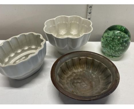 A selection of Victorian ceramic jelly moulds and a Victorian glass dump paperweight 