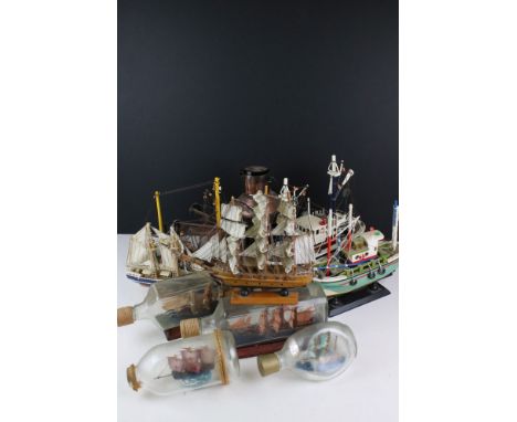 Four Model Ships in Glass Bottles, largest 27cm long together with Three Painted Wooden Models of Trawler Boats, Two Models o