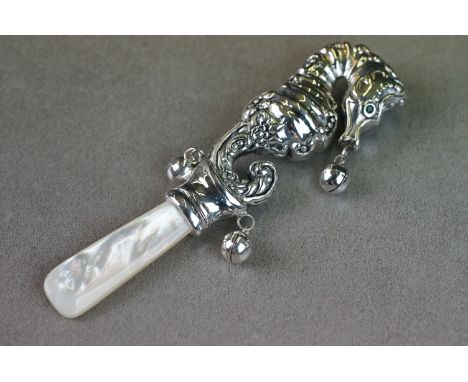 Silver babies rattle in the form of a sea horse with emerald eyes 