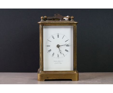 An antique brass cased carriage clock, maker marked to the face Howell James &amp; Co. 