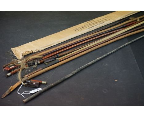 A collection of vintage violin bows. 