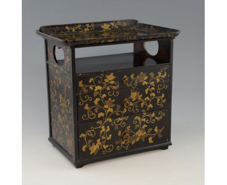 Early 20th century Japanese black lacquered cabinet with gilt decoration of flowers and foliage, the tray top over open secti