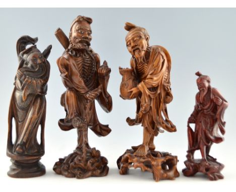 Chinese carved hardwood of a bearded man holding a bat and standing on one leg on a turtle, 33cm high, and three other simila