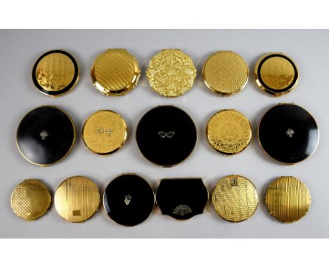 A collection of Stratton compacts with designs in black and gold, including three large size compacts with black enamel black