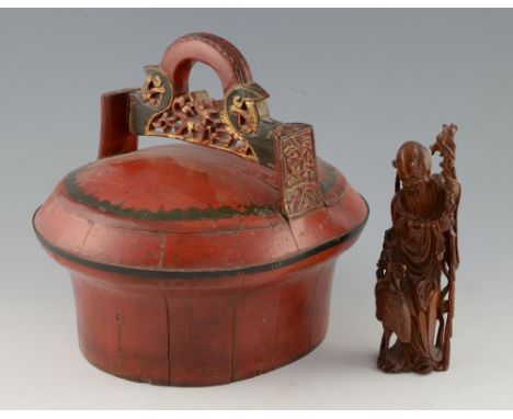 Chinese red lacquered box and cover with carved and pierced handle and painted decoration, 30cm high, and a carved hardwood f