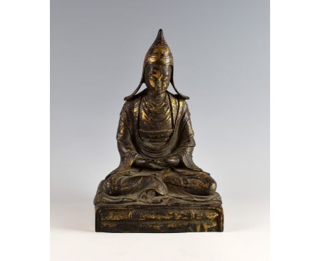 Sino-Tibetan cast bronze figure of Tsongkhapa on rectangular throne, with remnants of gilt and red lacquered decoration, reve