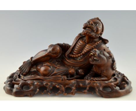 Chinese hardwood carving of a man reclining with a tiger, 20cm x 40cm,PLEASE NOTE: THIS ITEM CONTAINS OR IS MADE OF IVORY. Bu