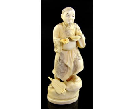 19th century Japanese carved ivory okimono of a man, holding a bowl in one hand, Meiji period, signed on base, 14 cms high. P