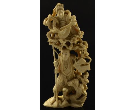 Early 20th century Japanese carved ivory group of a fisherman with a bamboo fishing rod, a lady playing a stringed instrument