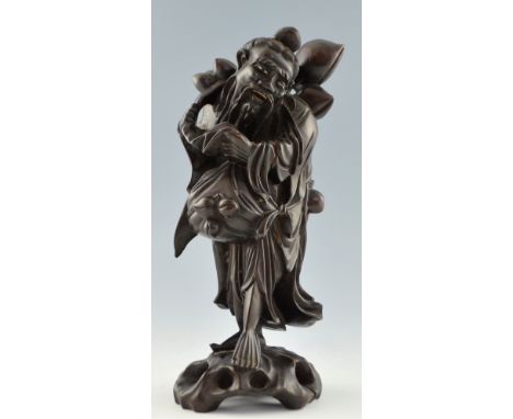 Chinese carved hardwood figure of a bearded man carrying a branch of peaches, 36cm high,PLEASE NOTE: THIS ITEM CONTAINS OR IS