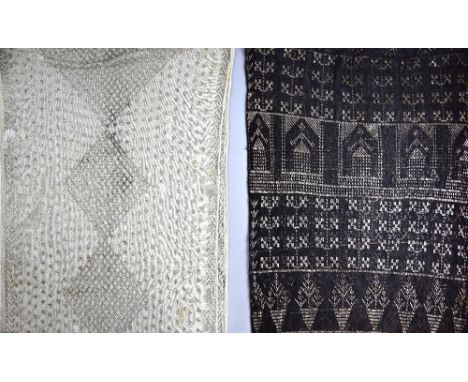 Two 1920's  Assuit shawls, with geometric decoration, one black (75 x 216 cm) the other cream (75 x 222 cm).    Black shawl i