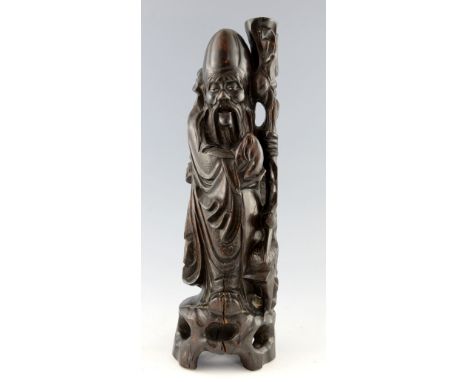 Chinese carved hardwood figure of Shou Lao, with his staff and holding a peach, inlaid wire decoration to his robe, 48.5cm,PL