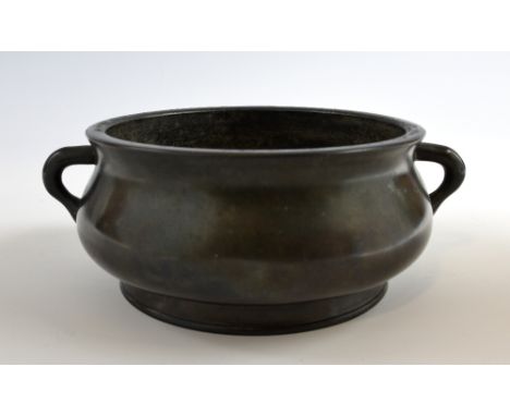 Chinese bronze twin-handled censer on round foot, raised four character mark to base, 21.5cm at widest point,.   