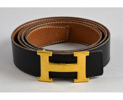 Hermes man's black and tan Constance reversible  belt with gold buckle stamped Hermes and leather marked 105 R.    Buckle has