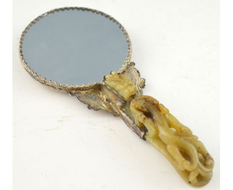 Chinese celadon jade belt buckle carved as a dragon and a bifid dragon, converted to the handle of a white metal hand mirror 