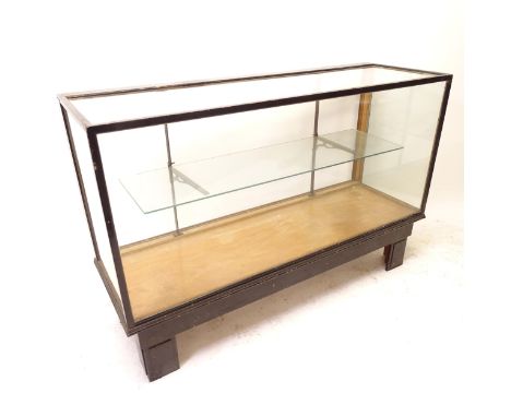 A Vintage lacquered wood framed and glass panel shop display cabinet, with open back and single adjustable shelf, L137cm, H91