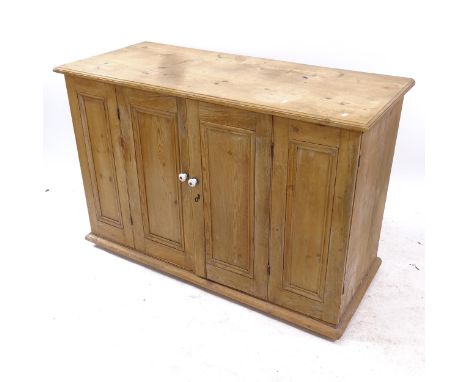 An early 20th century polished pine sideboard, with 2 bi-fold doors revealing interior with 4 fitted drawers and shelf, W128c