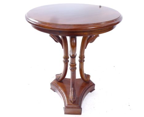 A reproduction mahogany circular lamp table, on bird carved legs and platform base, D50cm, H69cm 