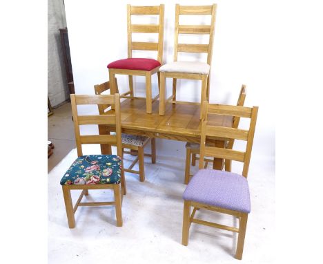 A modern light oak draw leaf dining table, L132cm, H76cm, D90cm, and 6 matching ladder-back chairs 