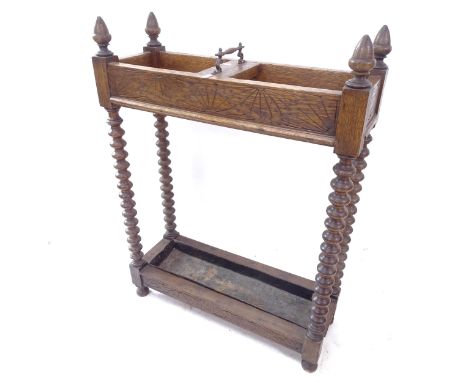 A 1920s stained oak stick/umbrella stand, with original drip tray, W61cm, H82cm, D22cm 