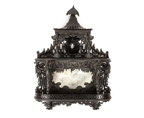 Set of ebonised wall shelvesof open fret form in the Chippendale style, 53cm wide x 72cm high  With losses and breaks.