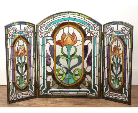 Stained glass triptych panel or firescreen Contemporary, the three sections decorated with flowers and scrolling borders, 71.