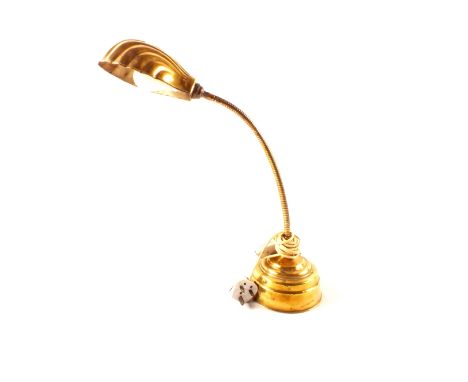A brass adjustable table lamp with shell shaped shade